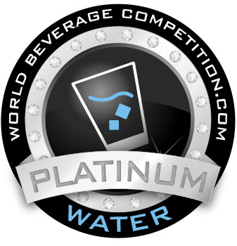 Circular Award Badge for World Beverage Competition Platinum Water Black Disk with Diamond Border Ribbon Across Center Reading Platinum and a Stylized Glass Icon with a Blue Wave Inside